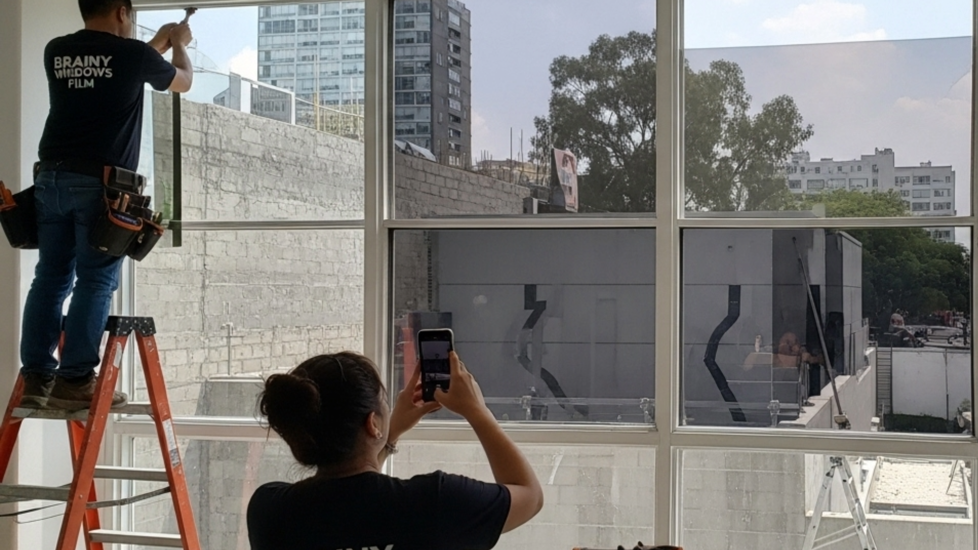 Proyectos 17 Fachada de edificio con película de espejo que refleja el cielo.
